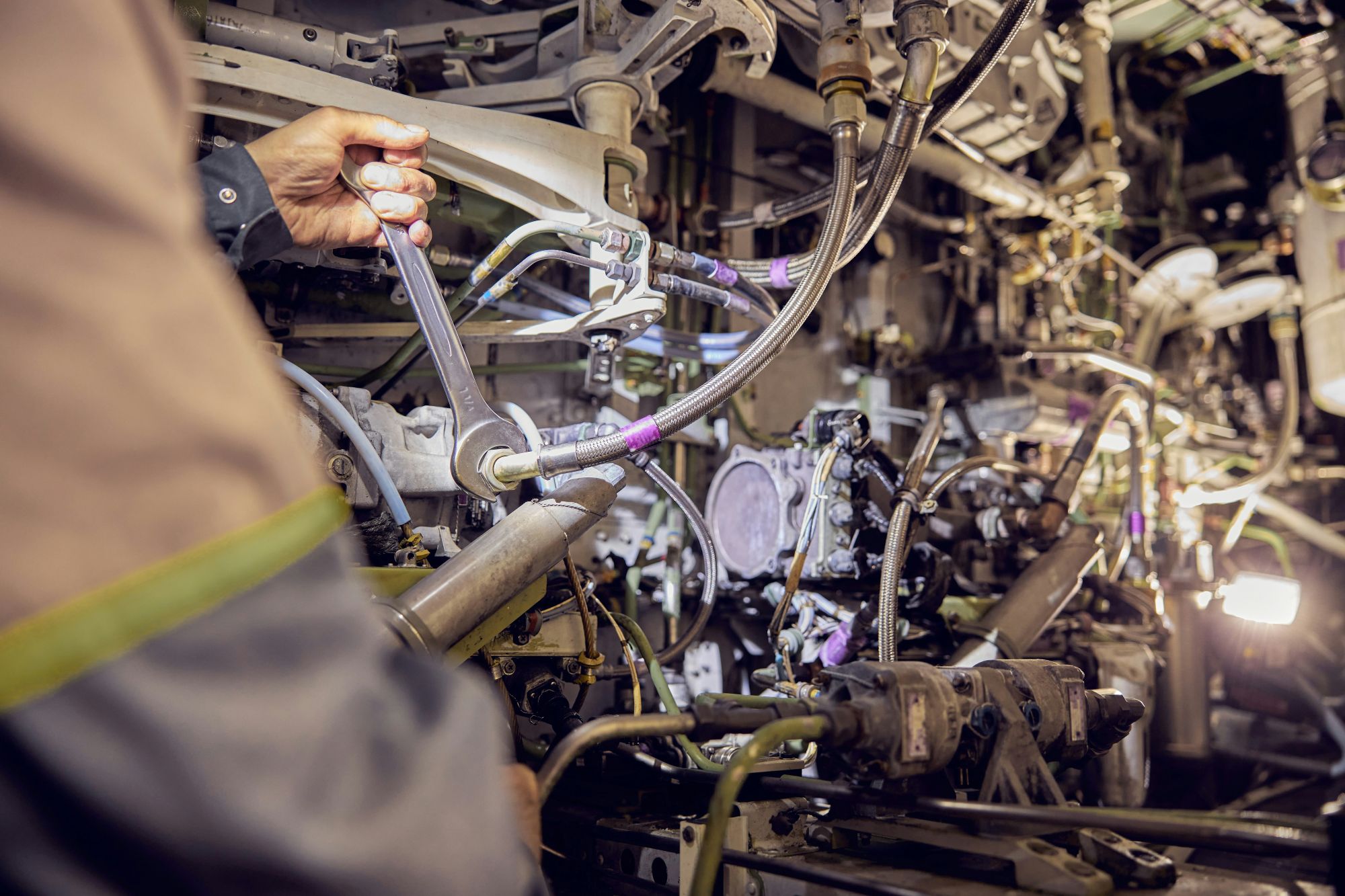 An engineer working on an engine
