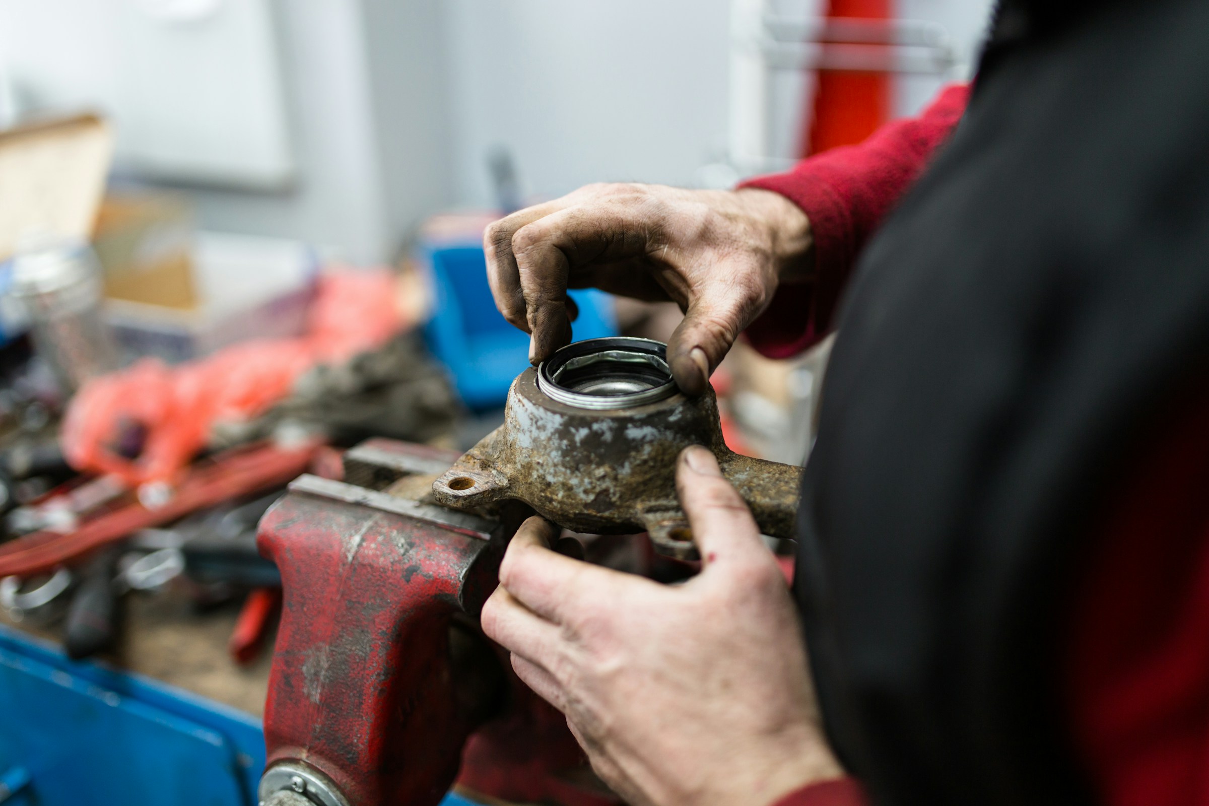 Close up of a mechanics hands working on an engine bearing